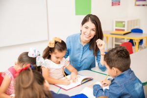 Teacher teaching kids to write
