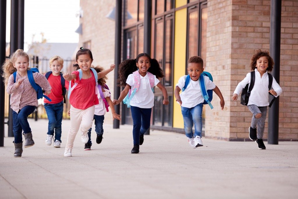 children happily running in their school