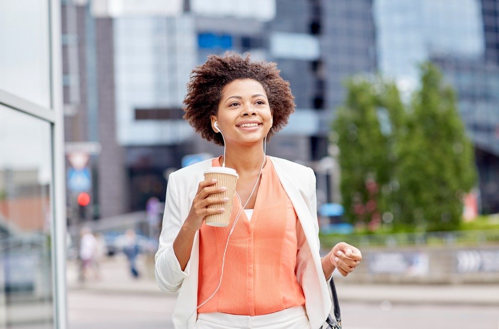 Happy businesswoman holding coffee