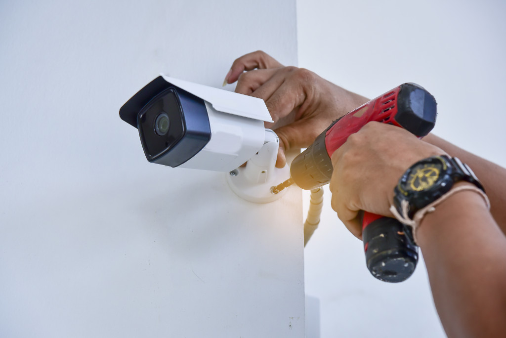 a person installing a security camera